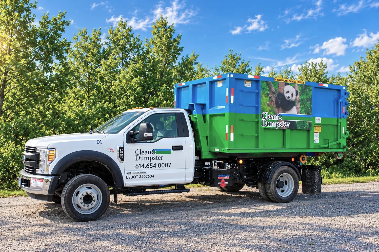 CleanE Dumpster truck carrying a container with panda artwork